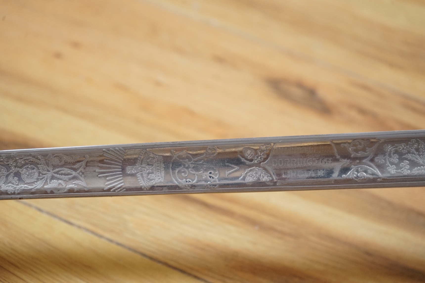 A George V 1897 pattern infantry officer’s sword, with regulation blade etched with the union flowers, Royal Arms and owners name; J.W. Reynolds, Dorrington, Lincoln, regulation nickel guard stamped ‘WH&S’ in minuscules,